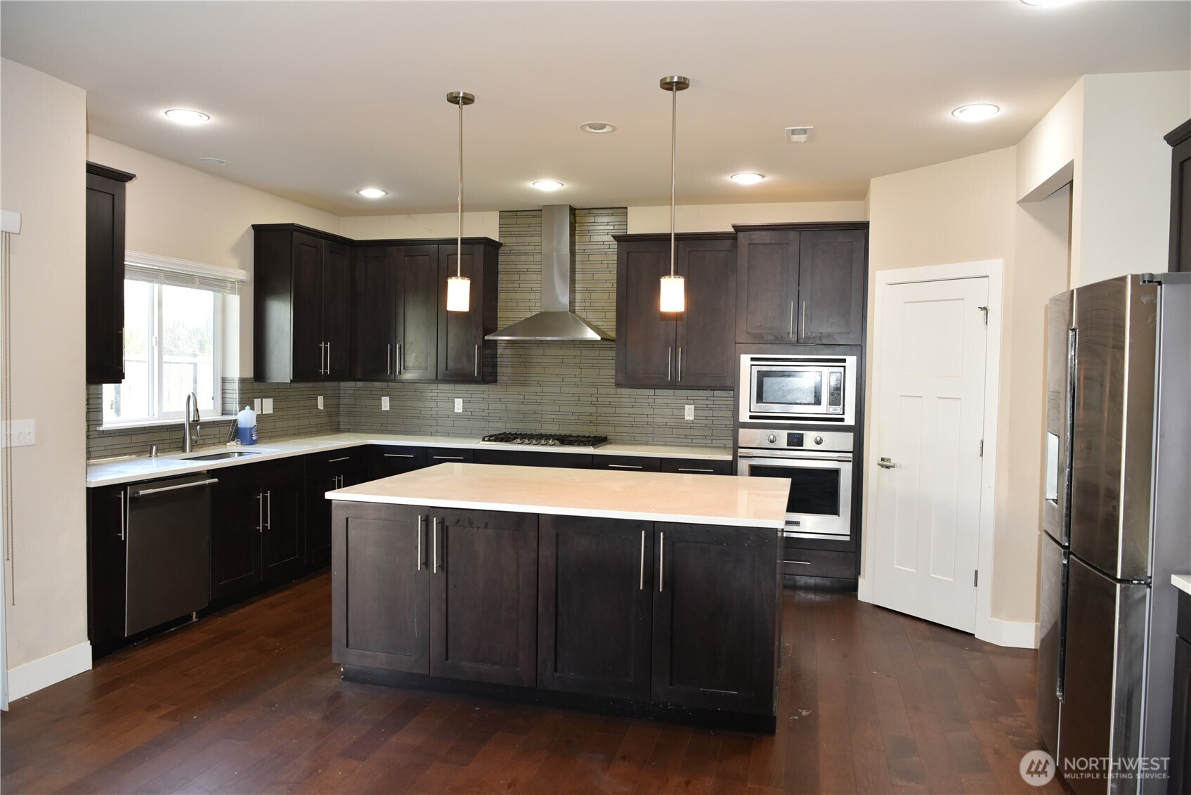 21417 43rd Drive Southeast, Unit 19 Bothell, WA 98021 - Photo 3 of 30 a large kitchen with a large counter top stainless steel appliances and cabinets