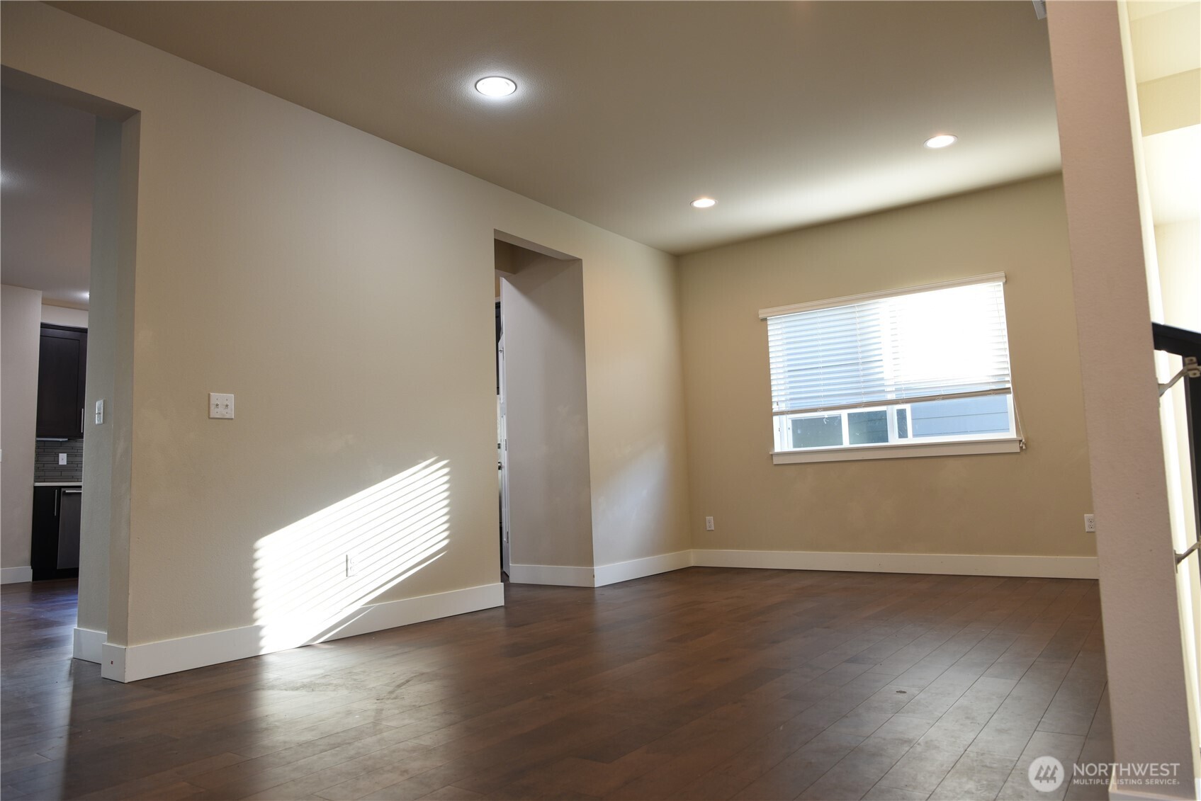 21417 43rd Drive Southeast, Unit 19 Bothell, WA 98021 - Photo 5 of 30 an empty room with wooden floor and windows