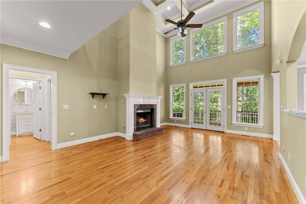 1040 Auburn Road Dacula, GA 30019 - Photo 22 of 42 a view of a livingroom with wooden floor and a fireplace