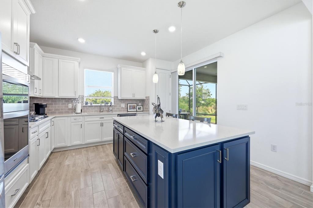 8706 Ocean Tides Cove Parrish, FL 34221 - Photo 13 of 63 a kitchen with a sink stove and cabinets