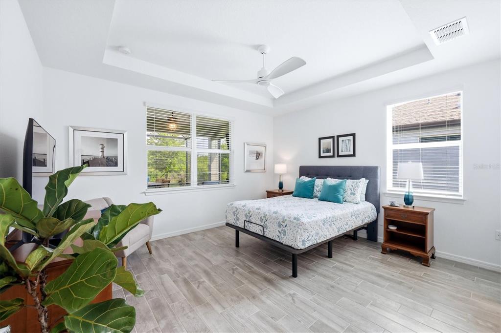 8706 Ocean Tides Cove Parrish, FL 34221 - Photo 19 of 63 a bedroom with a bed table and a window