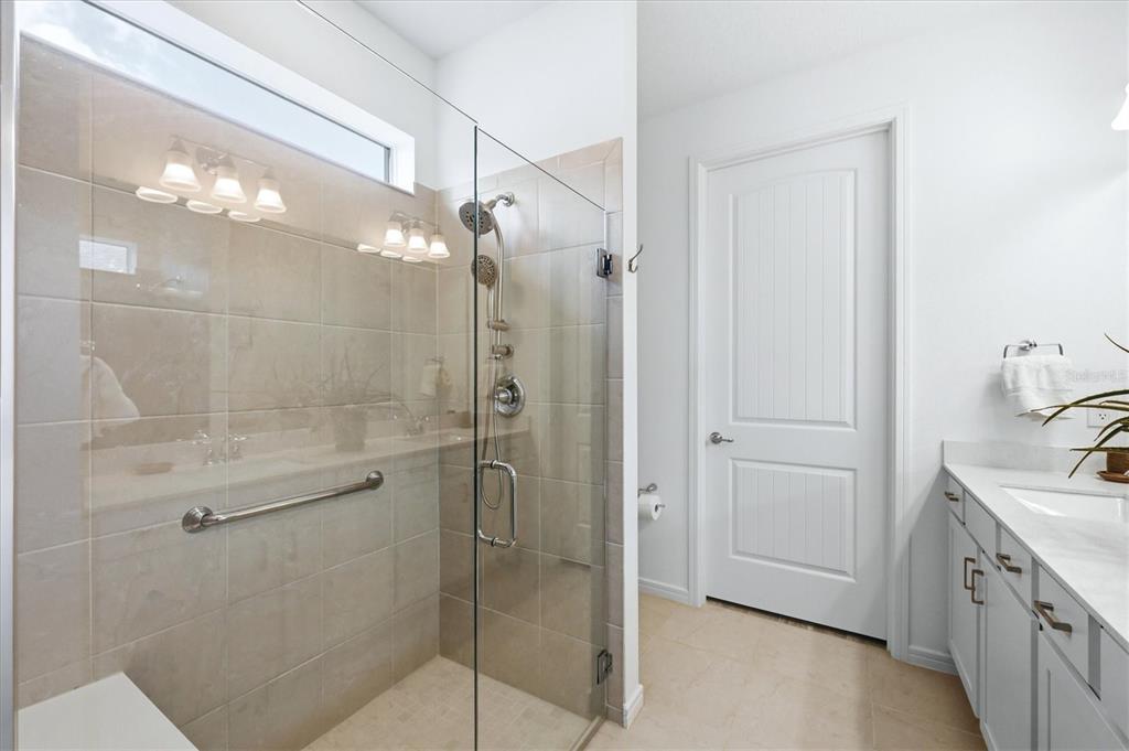 8706 Ocean Tides Cove Parrish, FL 34221 - Photo 21 of 63 a bathroom with a double vanity sink a toilet and shower