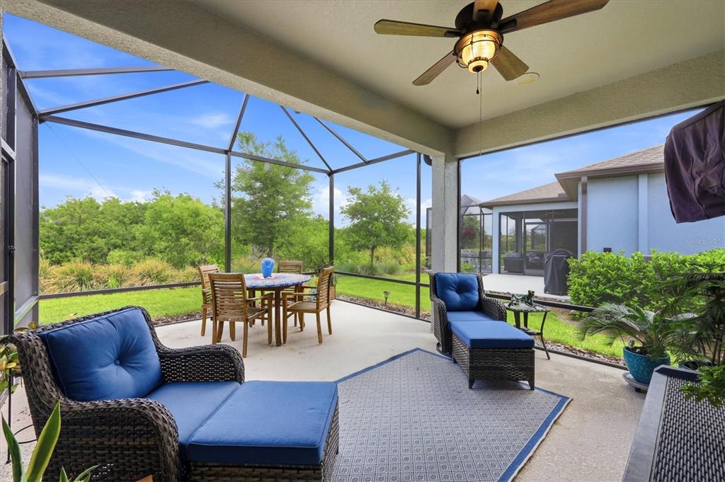8706 Ocean Tides Cove Parrish, FL 34221 - Photo 28 of 63 a view of a patio with couches potted plants and a table