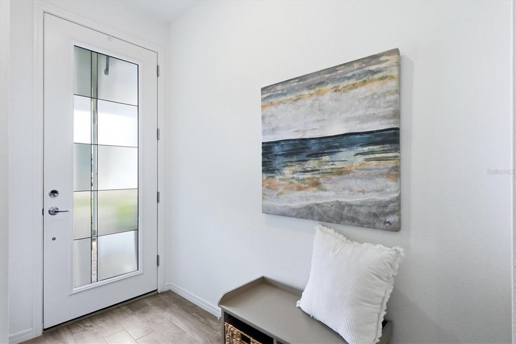 8706 Ocean Tides Cove Parrish, FL 34221 - Photo 4 of 63 a view of an empty room with wooden floor and a window