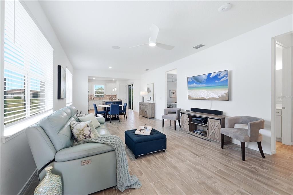 8706 Ocean Tides Cove Parrish, FL 34221 - Photo 5 of 63 a living room with furniture and a flat screen tv