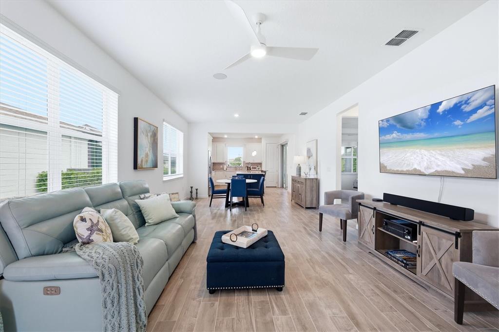 8706 Ocean Tides Cove Parrish, FL 34221 - Photo 6 of 63 a living room with furniture and wooden floor