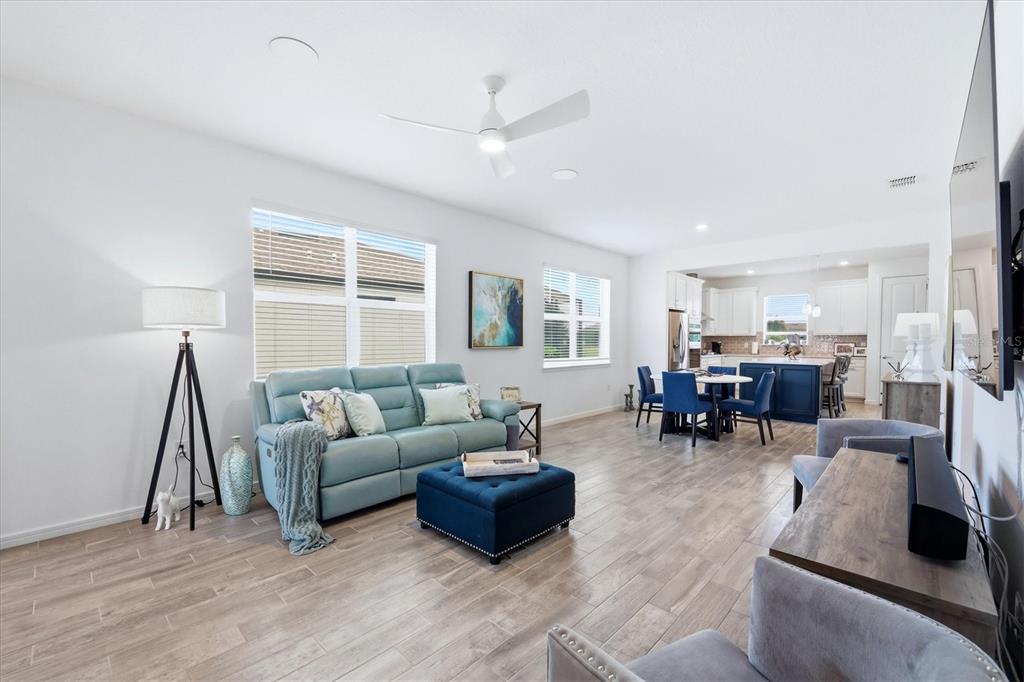 8706 Ocean Tides Cove Parrish, FL 34221 - Photo 7 of 63 a living room with furniture and a wooden floor