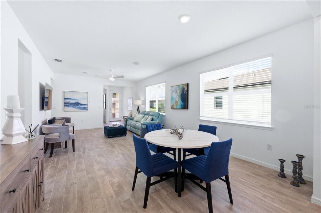 8706 Ocean Tides Cove Parrish, FL 34221 - Photo 9 of 63 a view of a dining room with furniture window and wooden floor