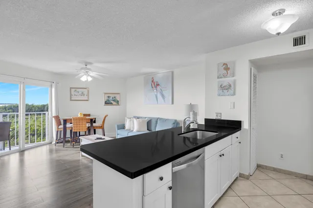 a kitchen with granite countertop a sink and a table