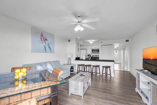 a view of a dining room with furniture a chandelier and wooden floor