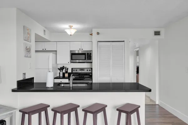 a kitchen with stainless steel appliances a refrigerator and microwave
