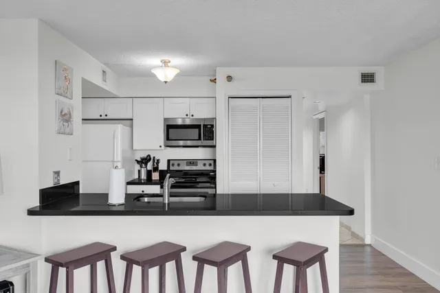 a kitchen with stainless steel appliances a refrigerator and microwave