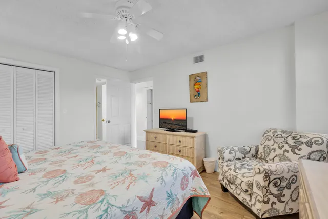a bedroom with bed and a flat screen tv