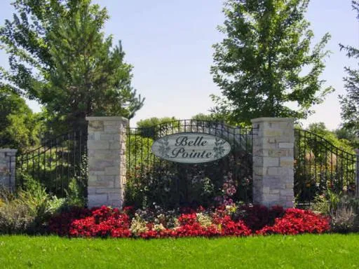 a view of sign board with flower garden