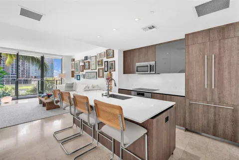 a kitchen with a sink and a stove with a dining table