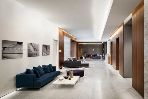 a living room with furniture and a book shelf