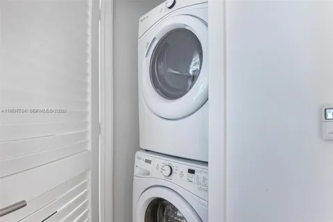 a view of a kitchen with a sink and a large window