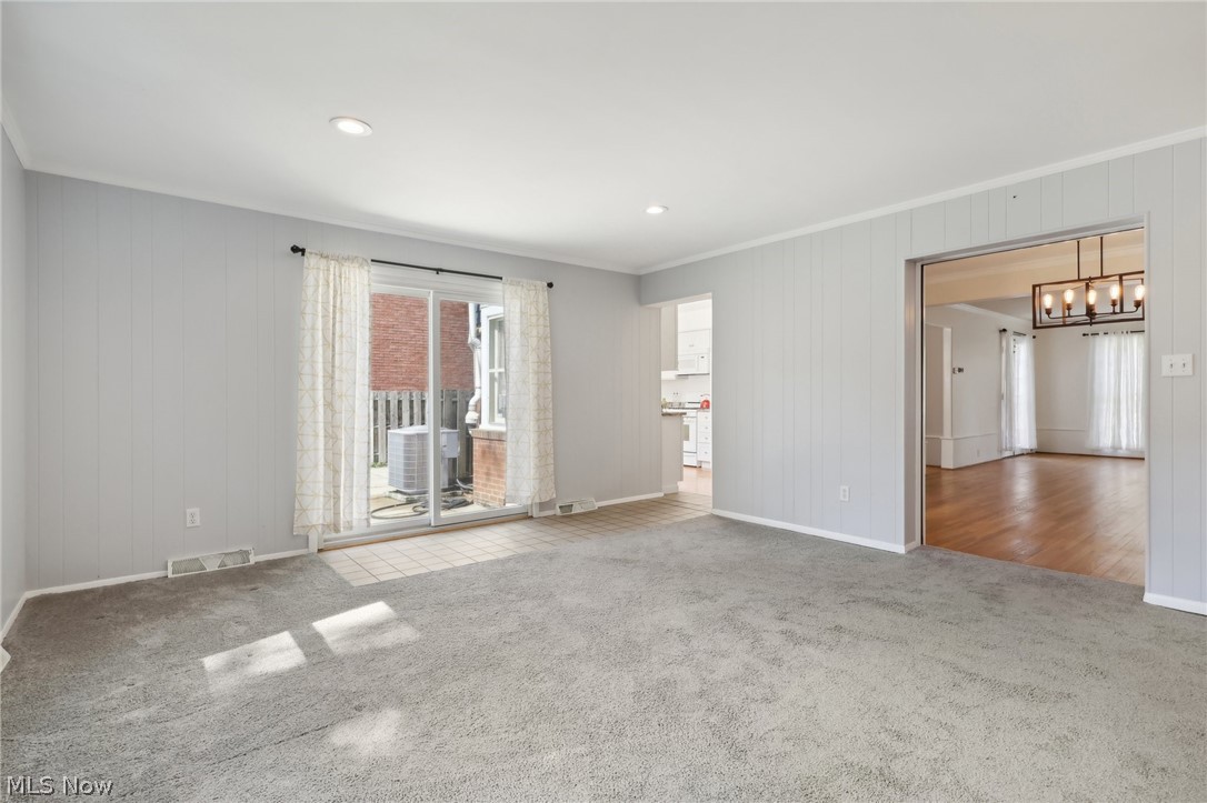 2620 Charney Road Cleveland, OH 44118 - Photo 16 of 43 Spare room featuring carpet floors and ornamental molding