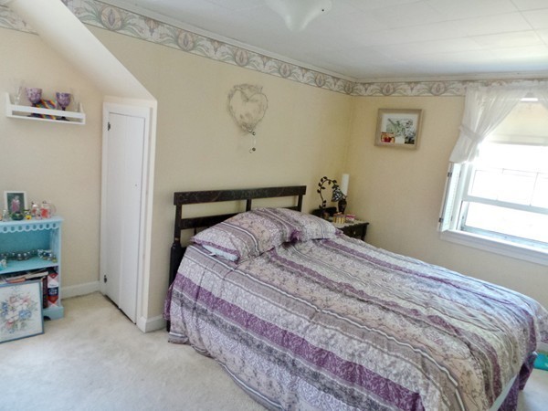 163 Whalom Road Lunenburg, MA 01462 - Photo 17 of 20 a bedroom with a bed and a window