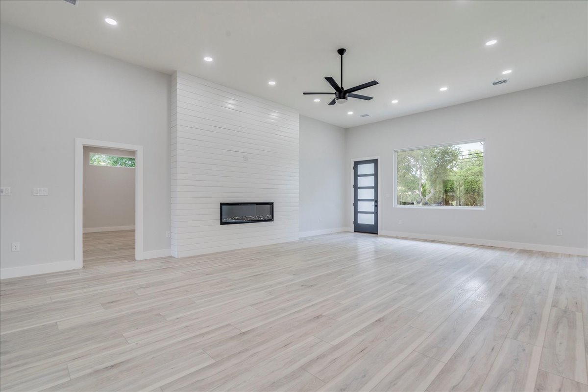 1215 Howard Street Taylor, TX 76574 - Photo 7 of 37 Living room with healthy amount of natural light, a fireplace, recessed lighting, ceiling fan, and light wood finished floors