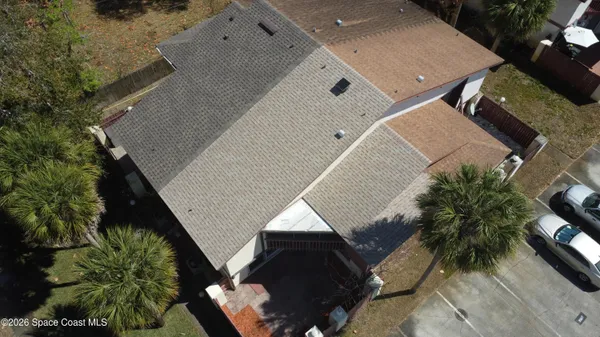 an aerial view of a house with a yard and potted plants