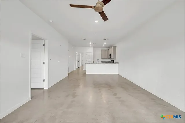 a view of a kitchen with a sink and cabinets