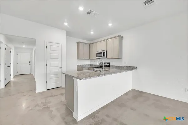 a view of a bathroom with a sink mirror and shower