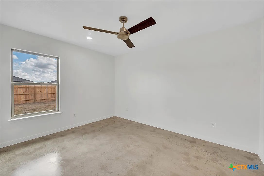 908 Smoke Tree Lane, Unit A Killeen, TX 76543 - Photo 6 of 13 an empty room with a window and a ceiling fan