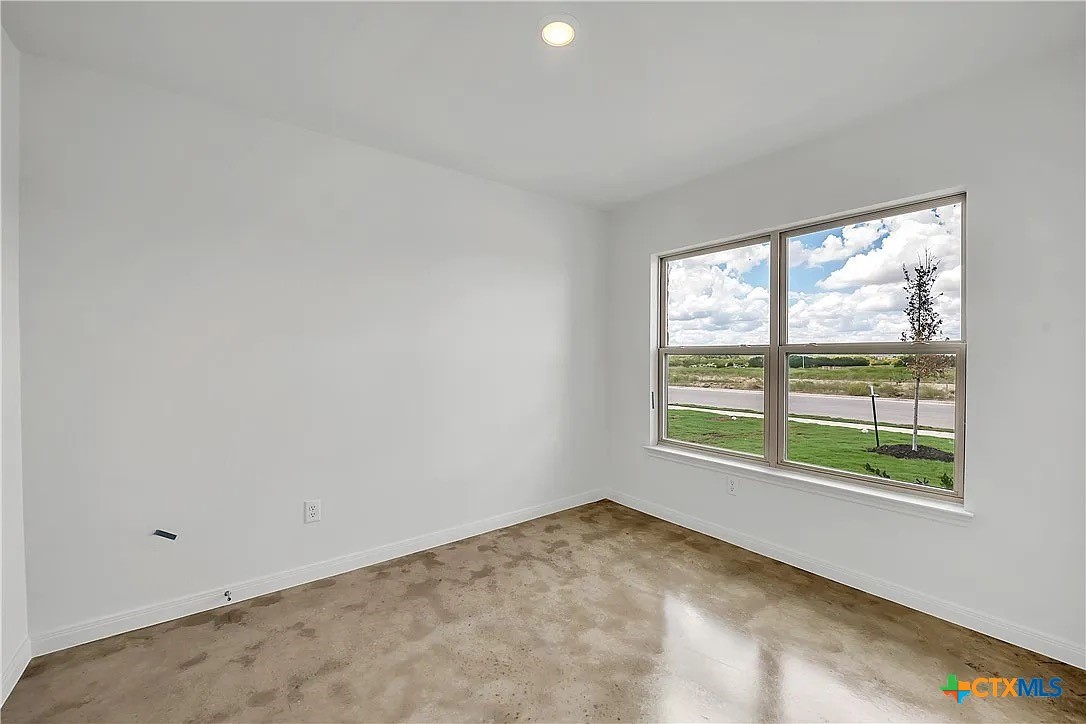 908 Smoke Tree Lane, Unit A Killeen, TX 76543 - Photo 9 of 13 an empty room with a window