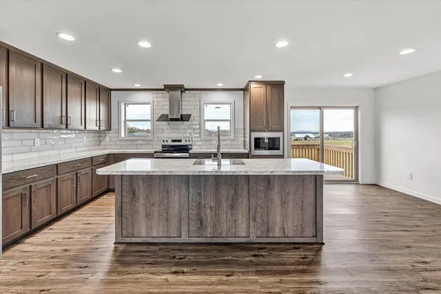 a bathroom with a granite countertop sink a toilet and a mirror