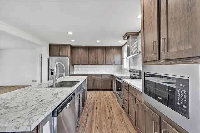 a view of a hallway with wooden floor and closet
