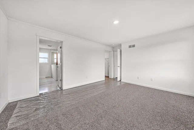 a view of an empty room with white walls