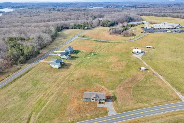 a large kitchen with stainless steel appliances granite countertop a sink a stove a counter space and a large window