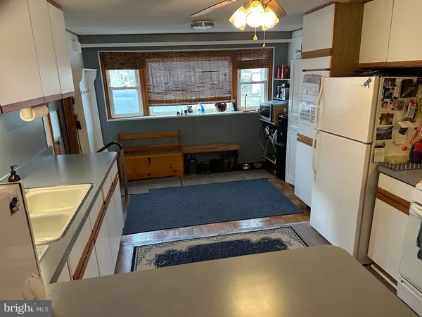 a kitchen with refrigerator and window