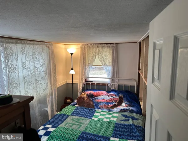 a bed room with a bed and a window