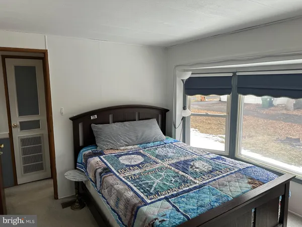 a bedroom with a bed and balcony