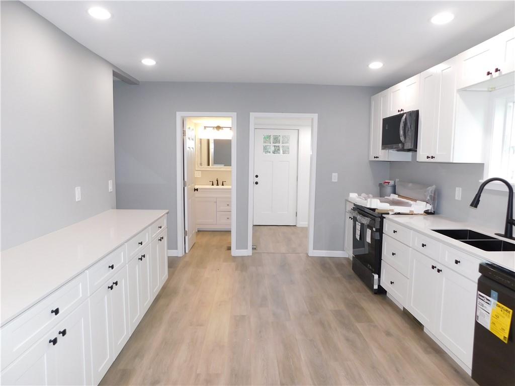 408 3rd Street Allison, PA 15413 - Photo 14 of 40 a large kitchen with granite countertop a lot of counter space and wooden floor