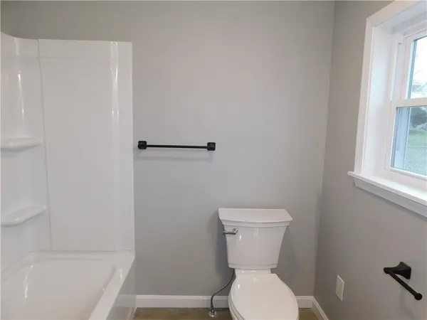 a bathroom with a toilet and a bathtub