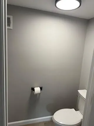 a white toilet sitting next to a white sink