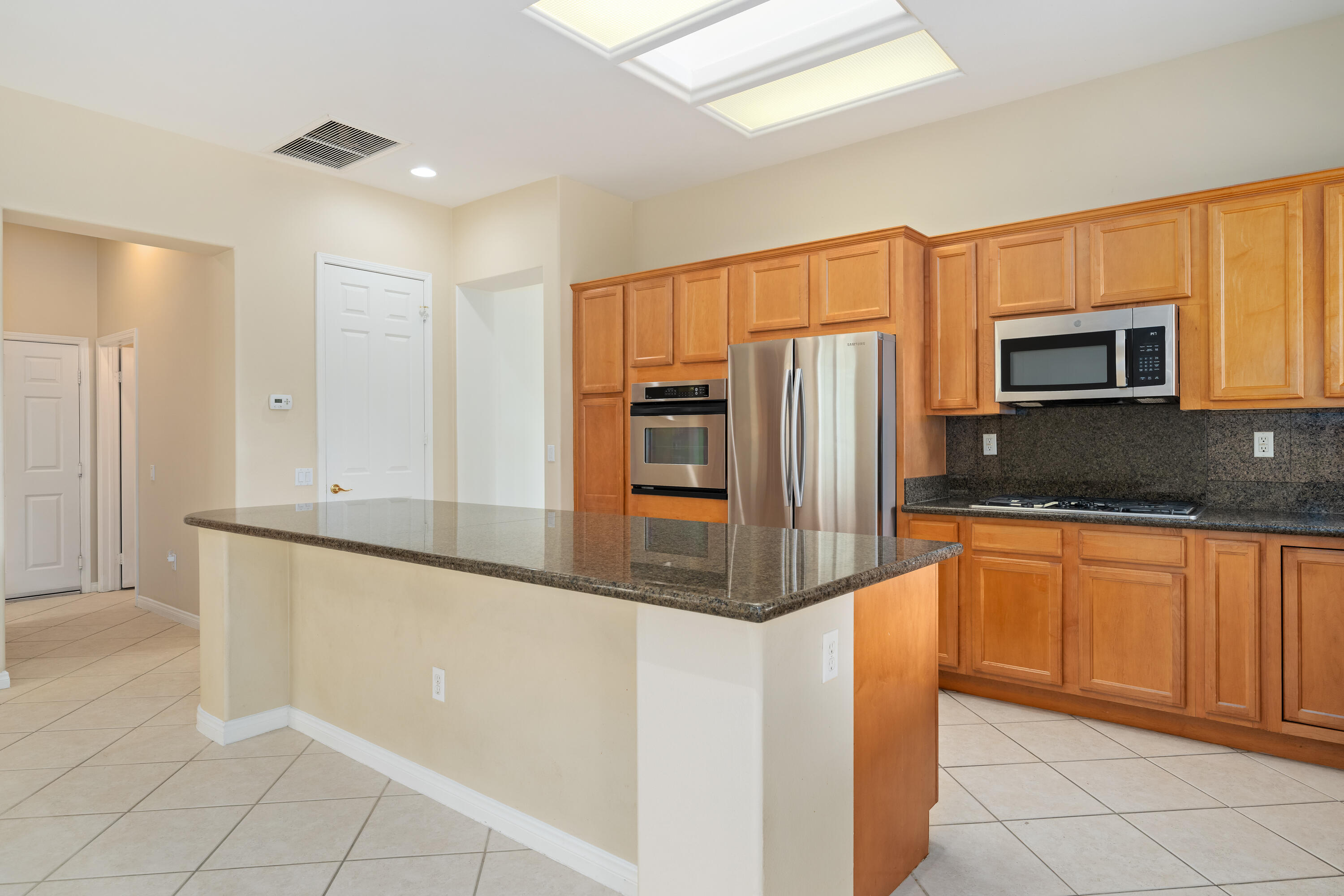 35260 Monarch Way Palm Desert, CA 92211 - Photo 19 of 44 a kitchen with granite countertop a refrigerator and a sink