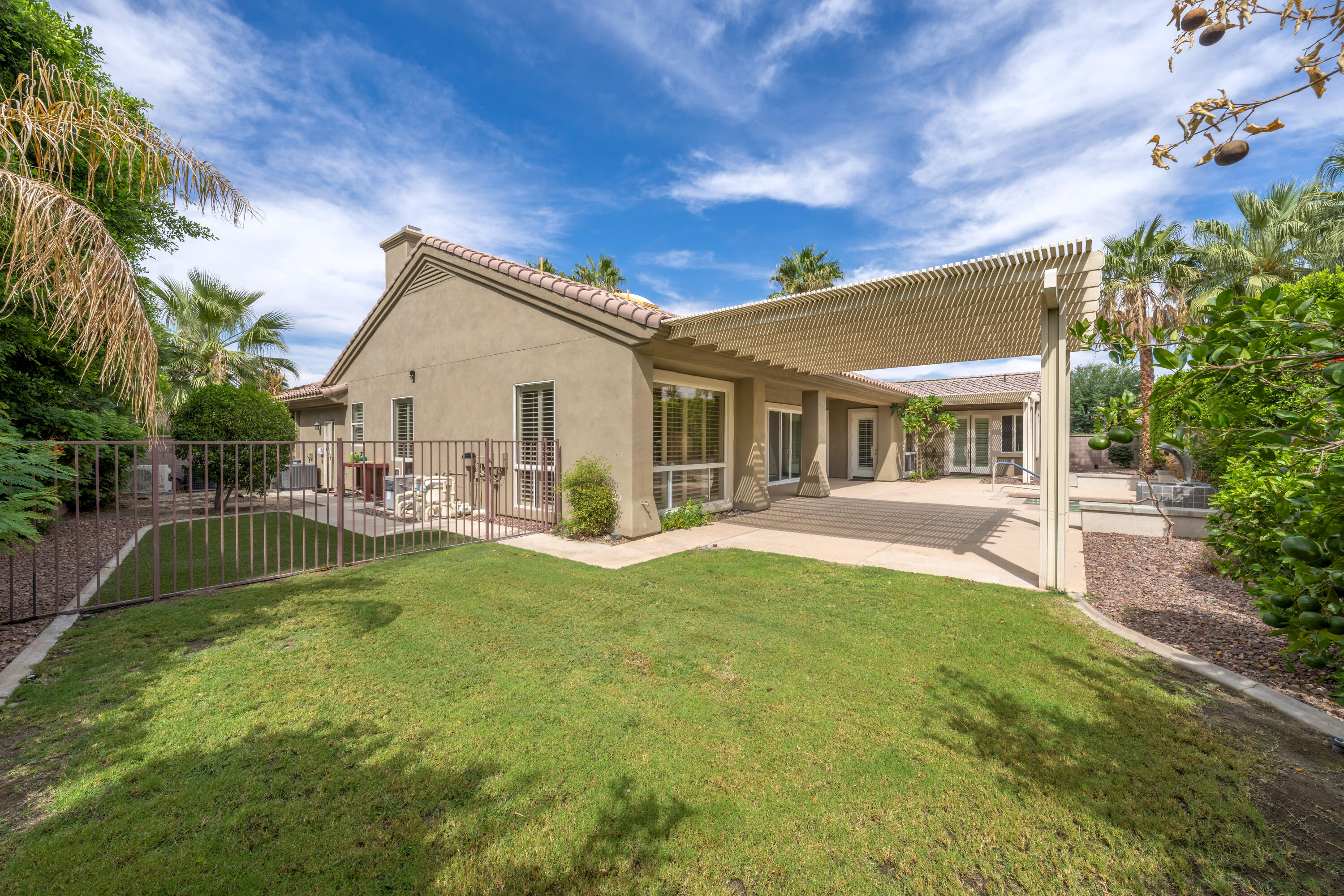 35260 Monarch Way Palm Desert, CA 92211 - Photo 3 of 44 a front view of a house with swimming pool having outdoor seating