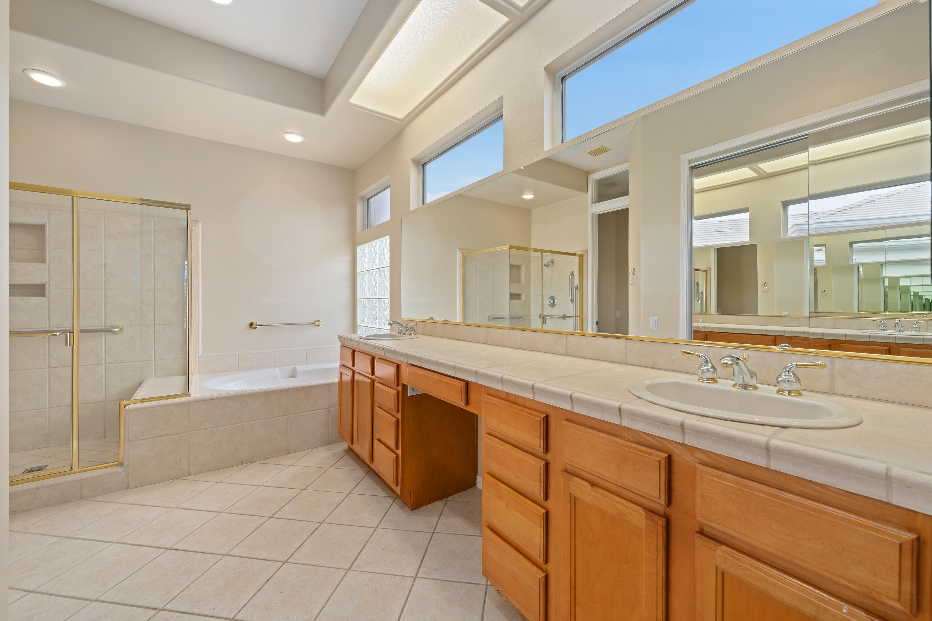 35260 Monarch Way Palm Desert, CA 92211 - Photo 32 of 44 a spacious bathroom with a granite countertop sink mirror and bathtub