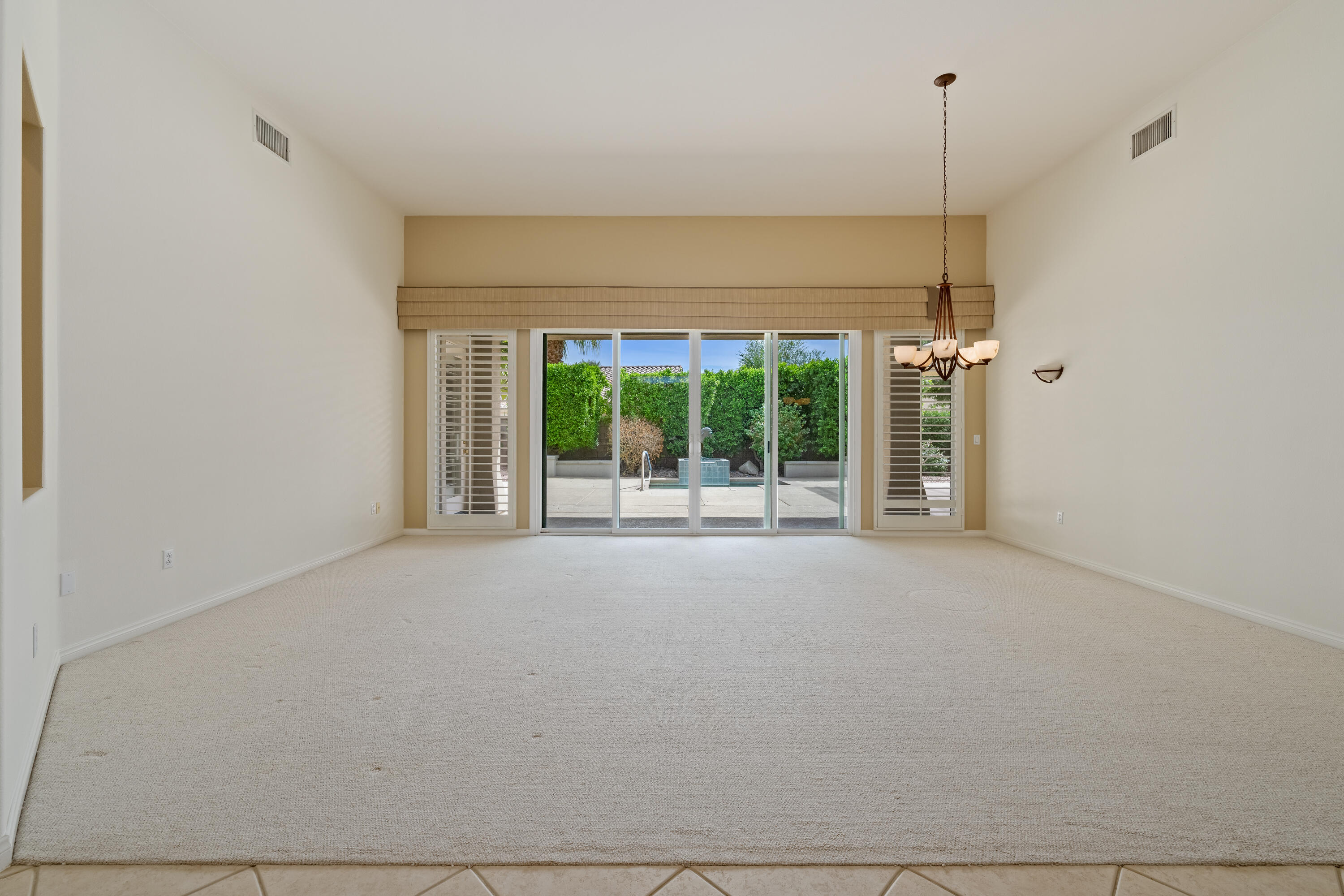 35260 Monarch Way Palm Desert, CA 92211 - Photo 10 of 44 a view of an empty room with a sliding door