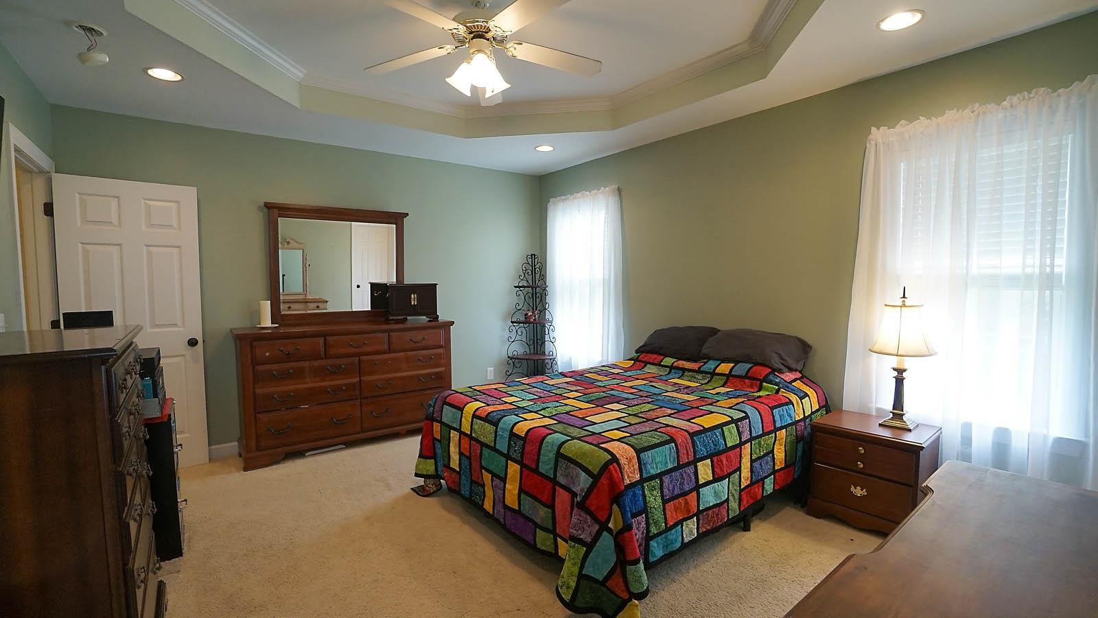 318 Jamison Drive Raleigh, NC 27610 - Photo 8 of 24 *Primary Bedroom w/ Trey Ceiling and Fan*View of Backyard and the Woods*