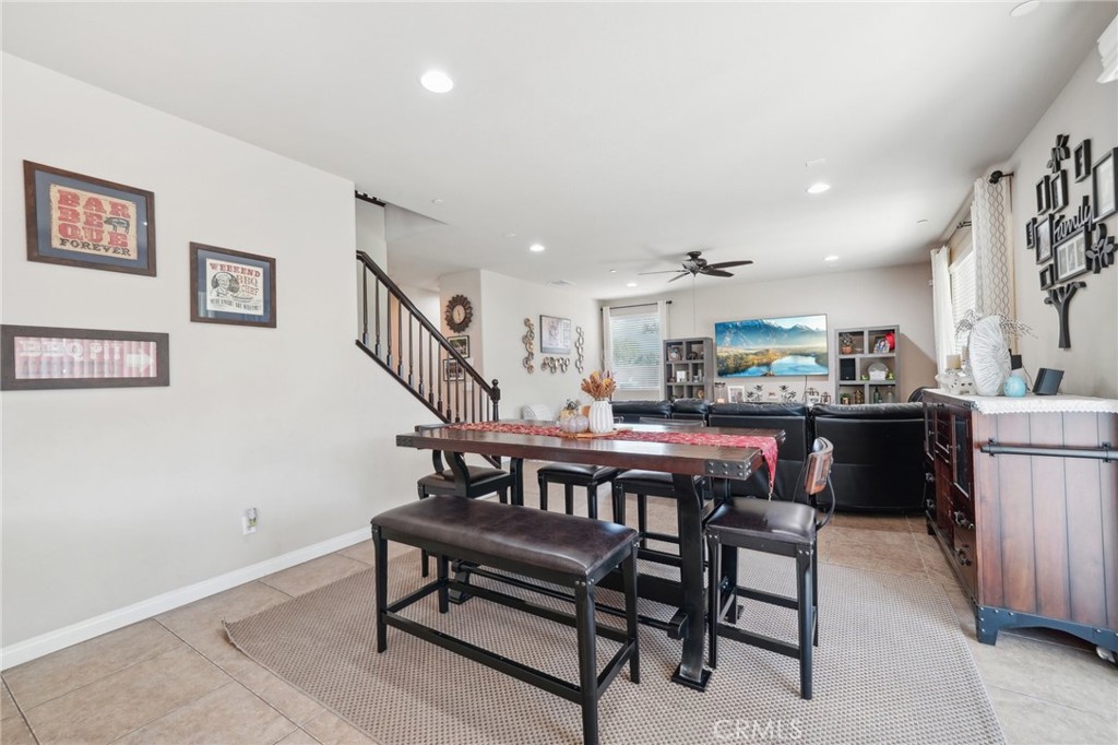 29259 Bouris Drive Menifee, CA 92584 - Photo 11 of 56 a kitchen with a dining table chairs and white cabinets