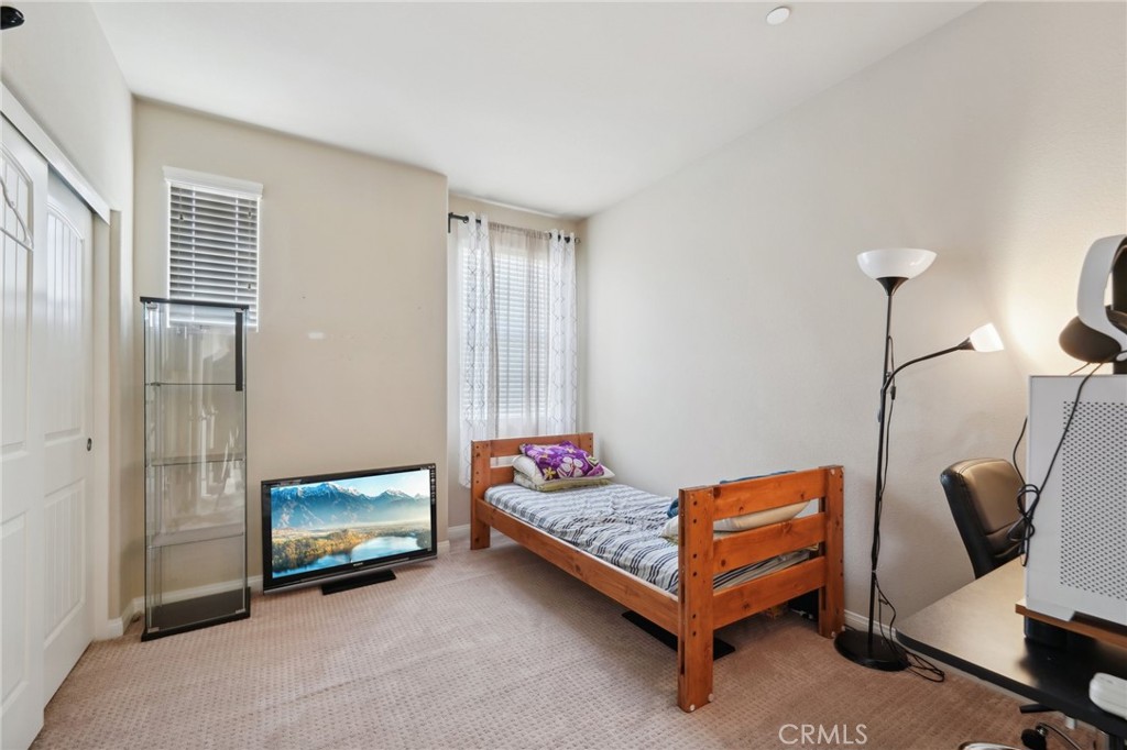 29259 Bouris Drive Menifee, CA 92584 - Photo 24 of 56 a living room with furniture and a floor to ceiling window