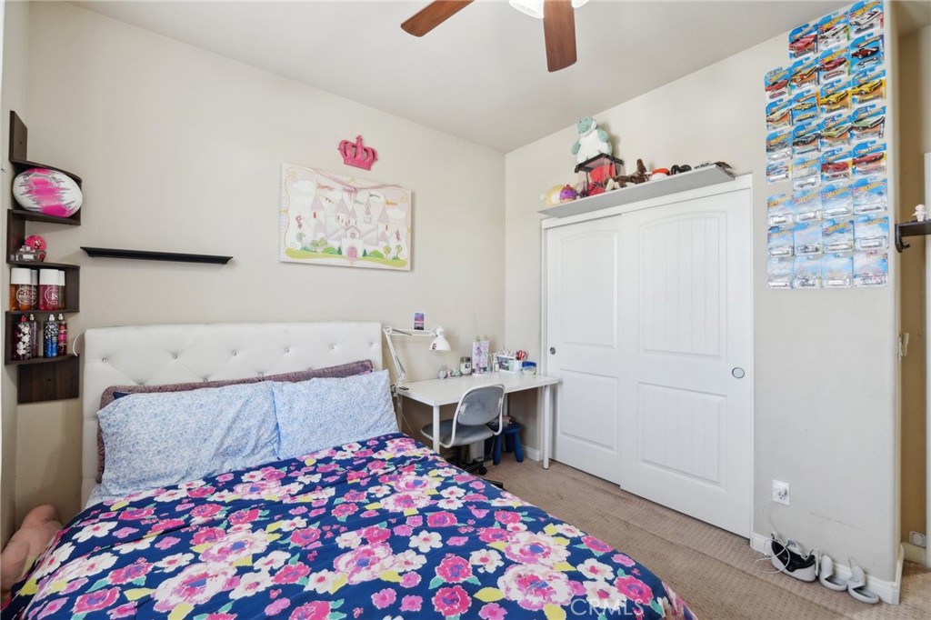 29259 Bouris Drive Menifee, CA 92584 - Photo 32 of 56 a bedroom with a bed and a chandelier