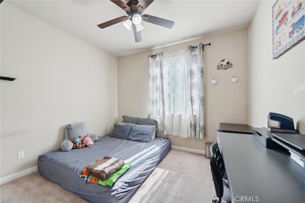 29259 Bouris Drive Menifee, CA 92584 - Photo 34 of 56 a bedroom with a bed and a chandelier