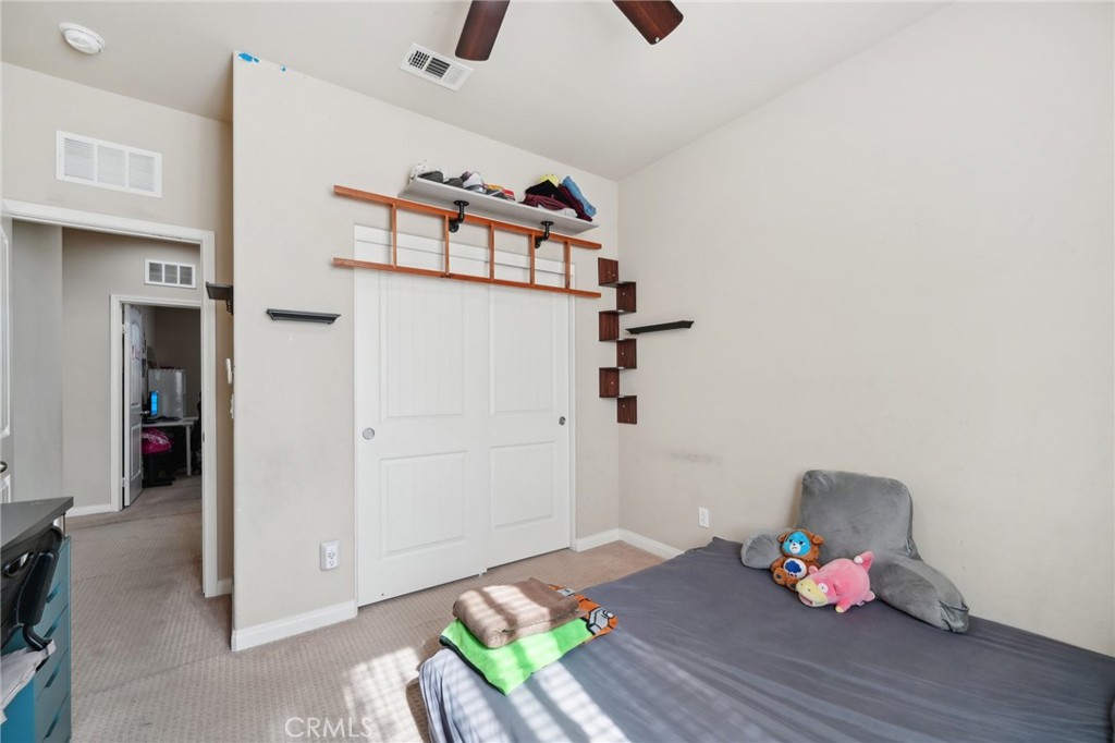 29259 Bouris Drive Menifee, CA 92584 - Photo 35 of 56 a bedroom with a bed and wooden floor