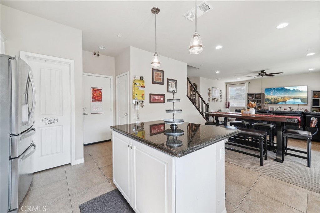29259 Bouris Drive Menifee, CA 92584 - Photo 10 of 56 a kitchen with stainless steel appliances granite countertop a sink a stove and a refrigerator
